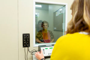 A CBU speech language pathology student conducting a hearing test